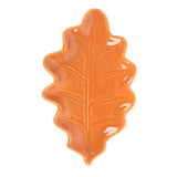 Orange leaf-shaped ceramic plate on a white background