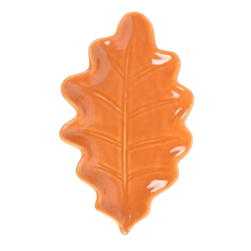 Orange leaf-shaped ceramic plate on a white background