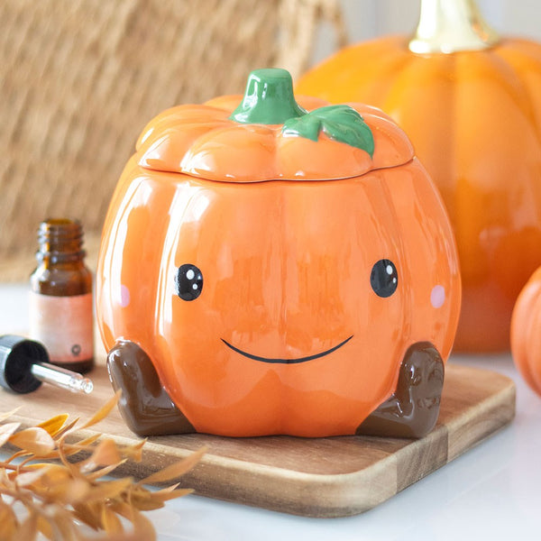 Pumpkin shaped oil burner with cute smiley face design